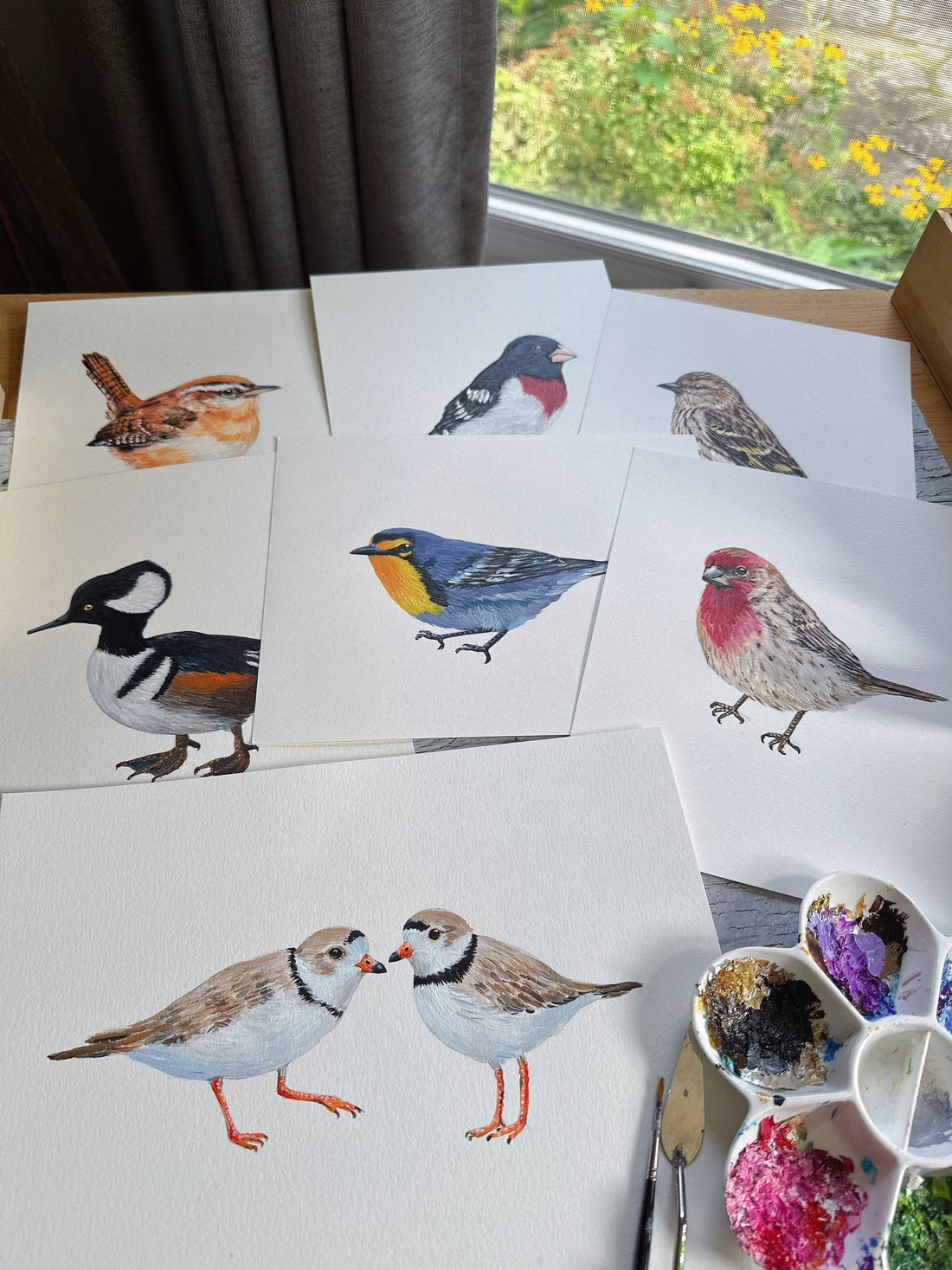 Hand-painted bird collection in Tiffany's studio