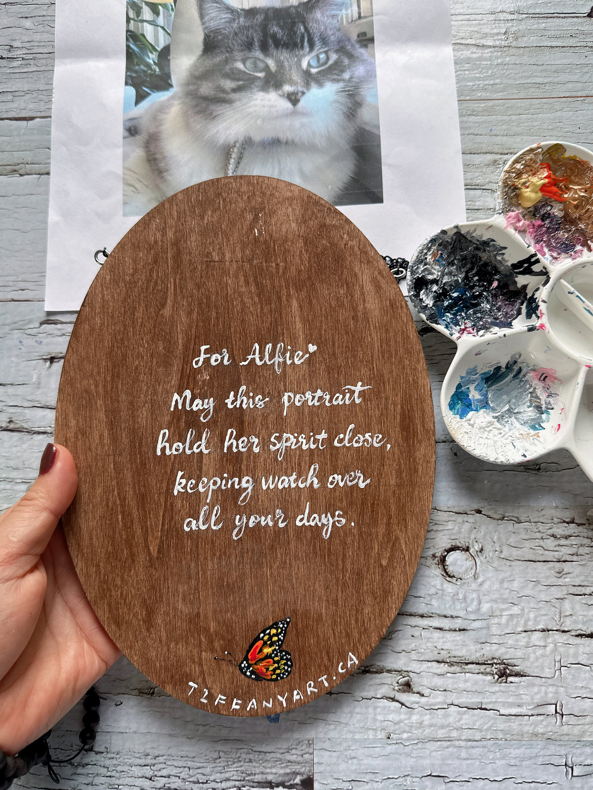 Back of the walnut wood plaque with a hand-lettered personal memorial message and a small painted butterfly